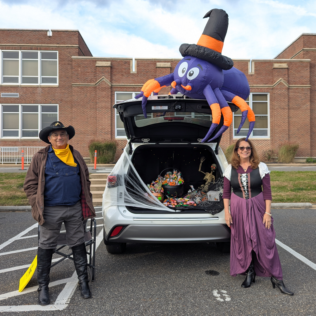 Giant blow up spider on top of the trunk which is filled with candy