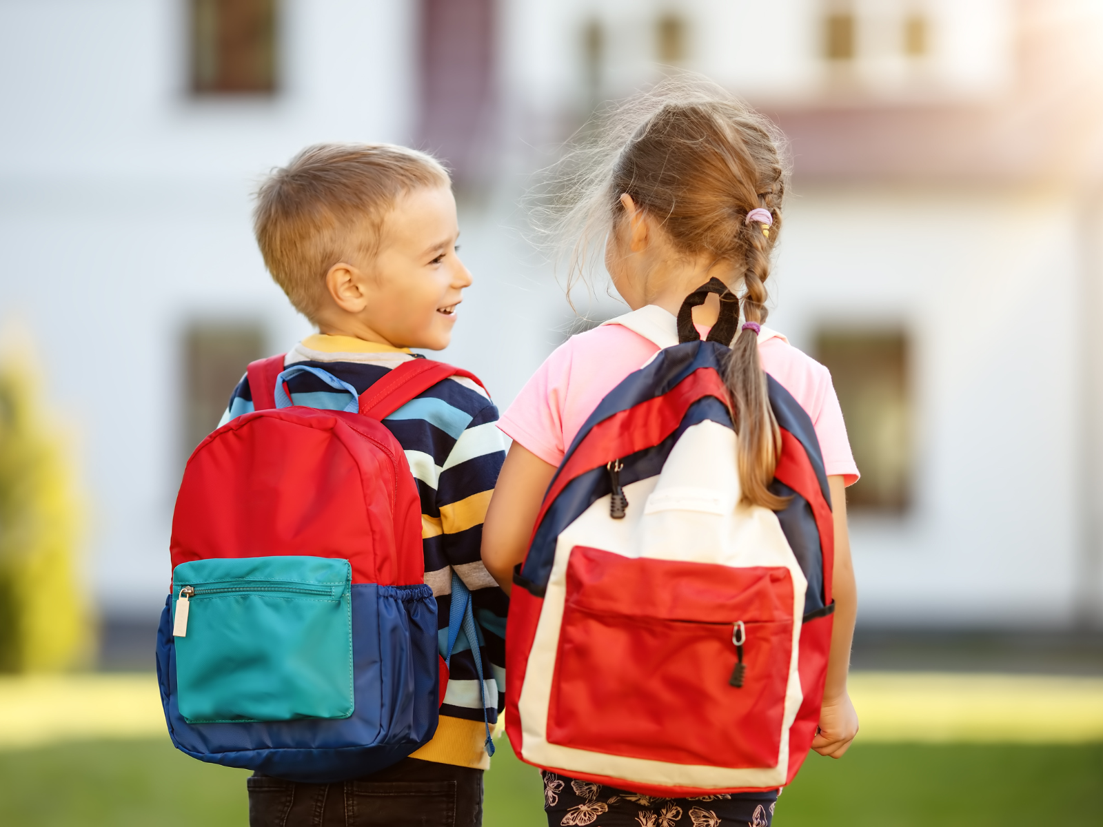 two kids wearing backpacks