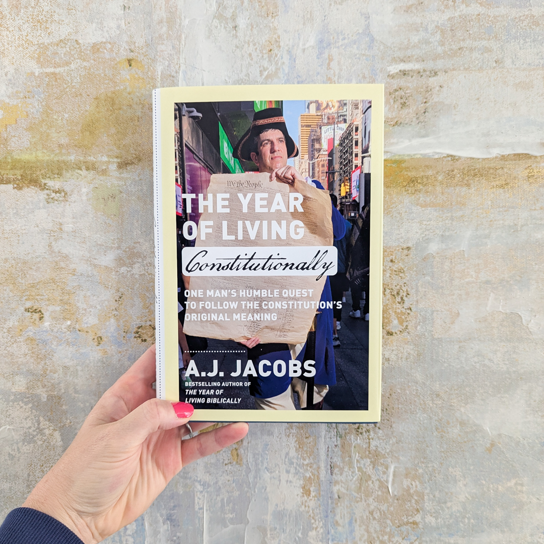 hand holding the book The Year of Living Constitutionally