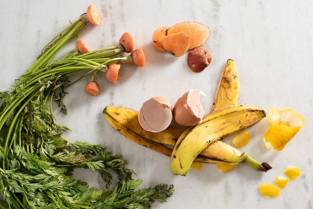 banana peel and other food scraps sitting on a counter