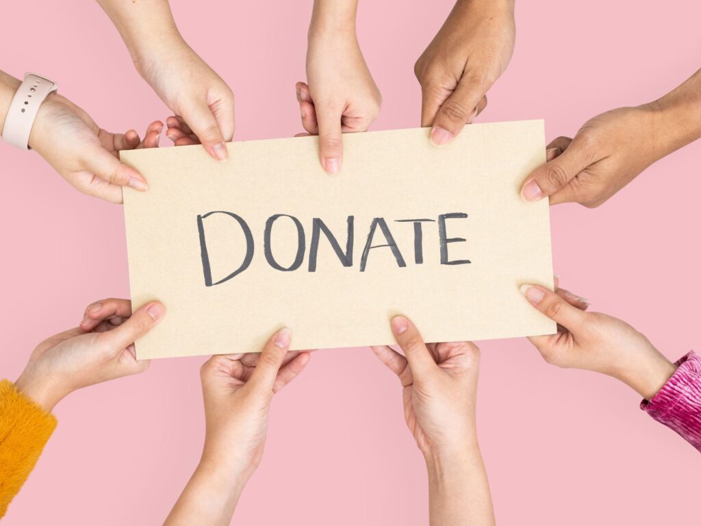 hands holding a card that says donation