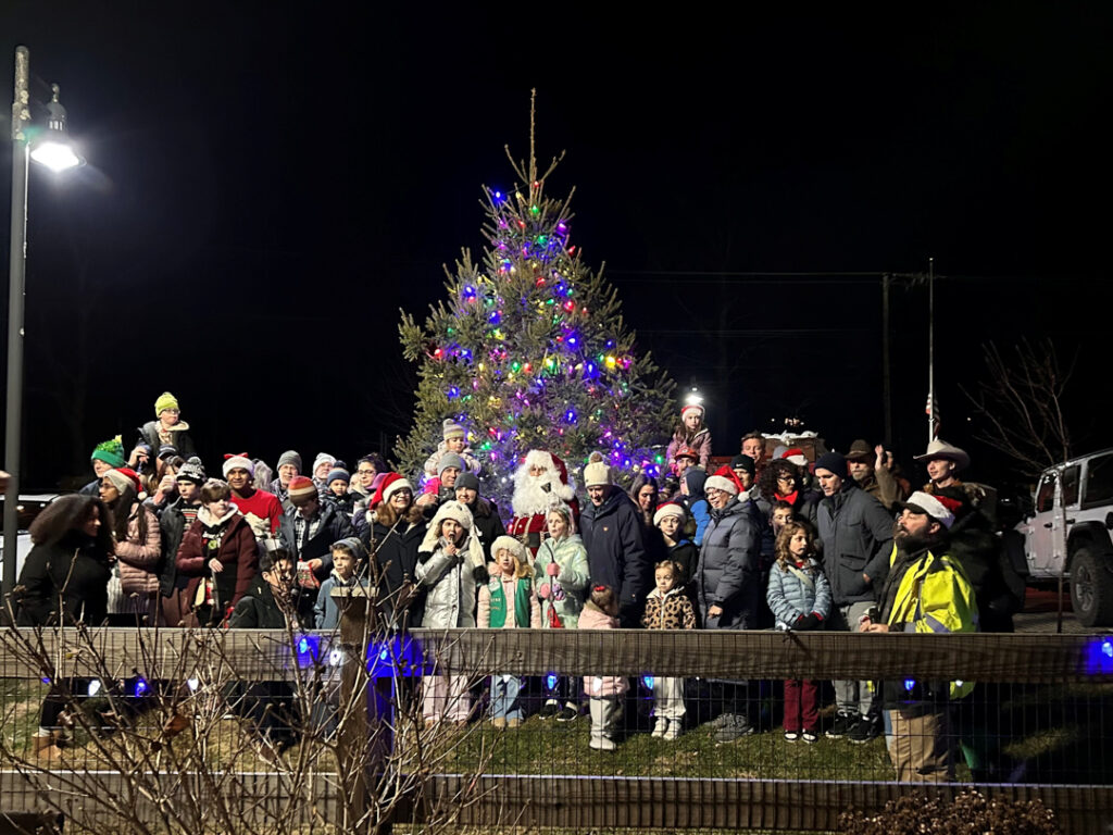 attendees in front of the tree after it was lit up for the annual holiday tree lighting