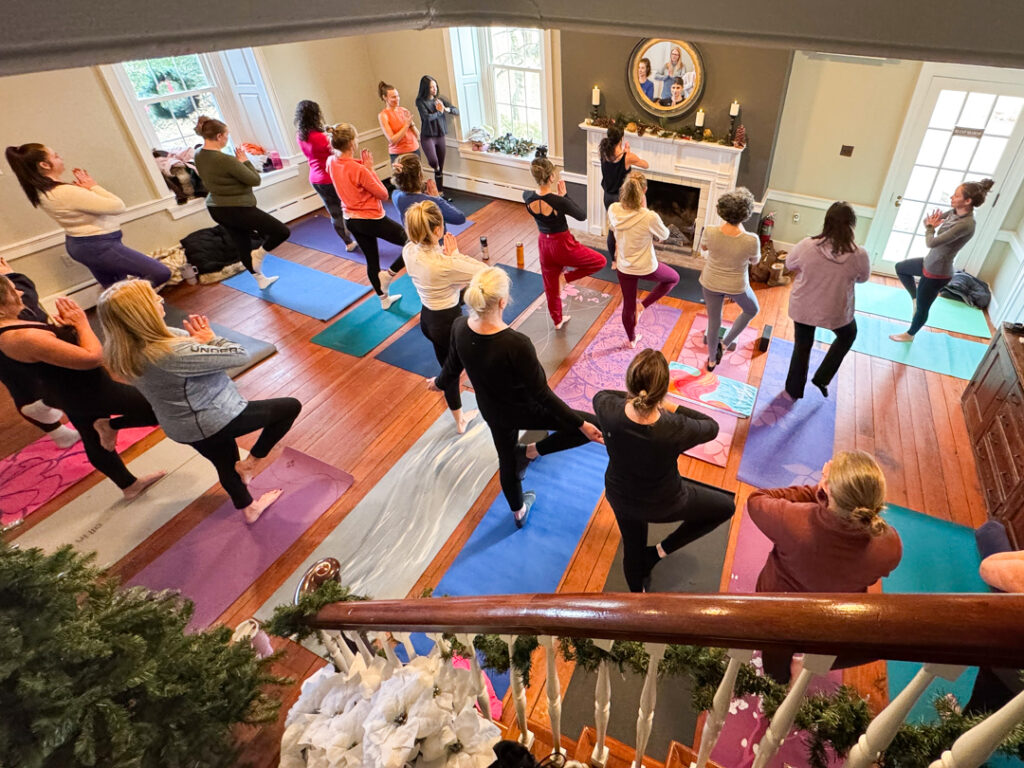 22 women doing yoga on their mats at the Chadds Ford winery