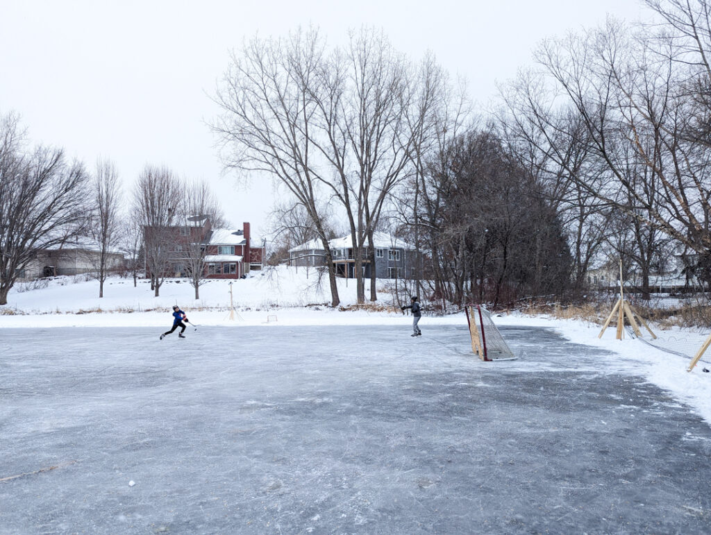 playing pond hockey on a frozen pond behind the house where I grew up