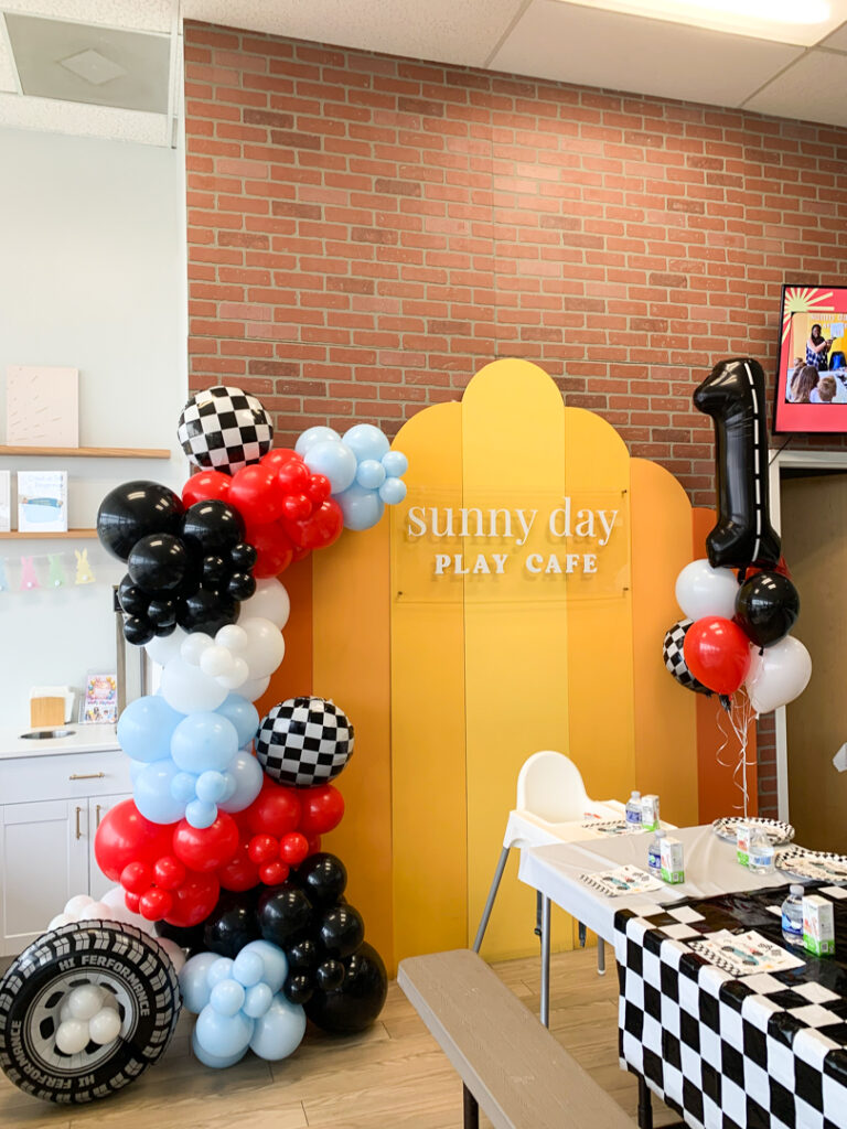 Black, red, light blue, and white balloon column for a party at Sunny Day Play Cafe