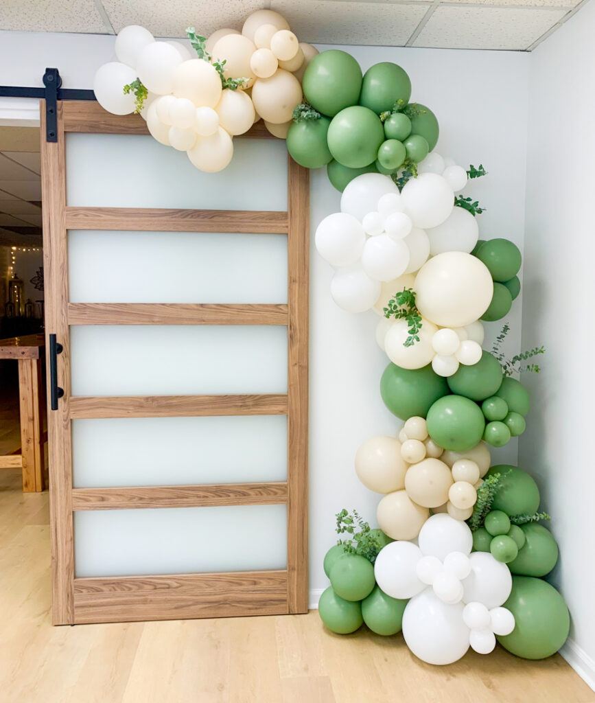 Green, white, and cream balloon garland at The Yoga Space from Pop on Pretty