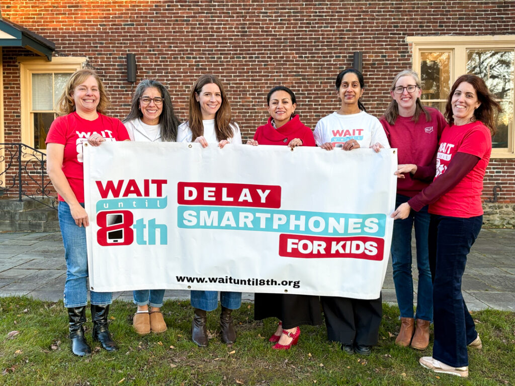 UCF Slowtech grassroots parent group in front of a Wait Until 8th sign