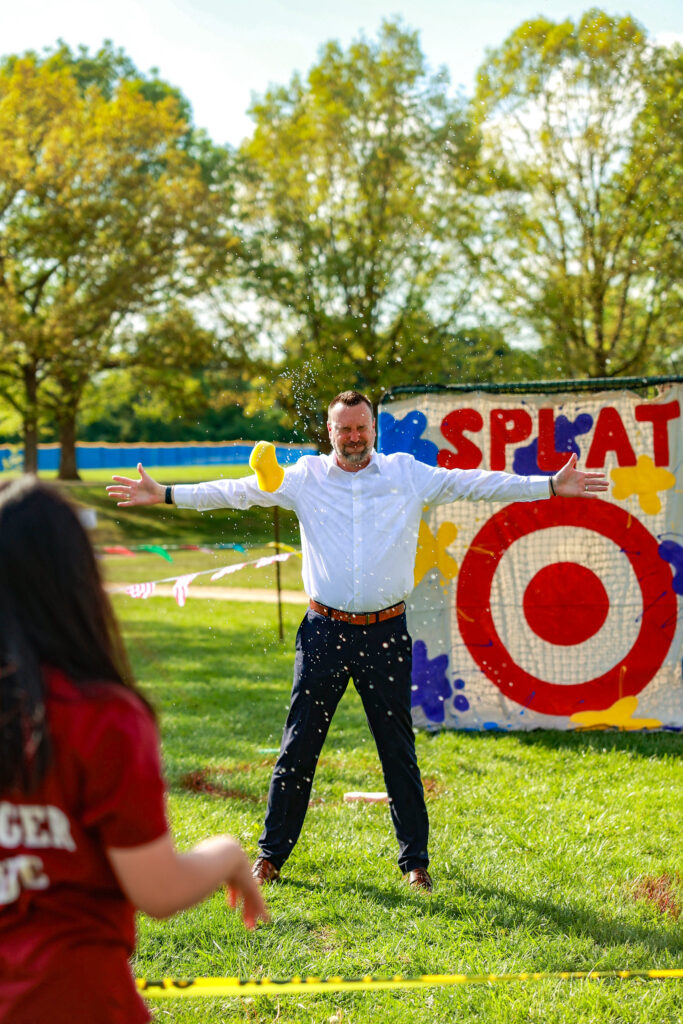 Superintendent Dr. Hoffman being splashed with a sponge at the Patton Spring Carnival