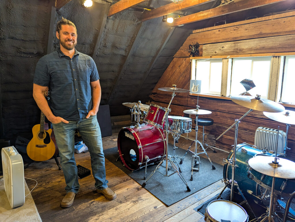 Owner Dave Mattock in the recording studio at Mattock School of Music, next to a drum set