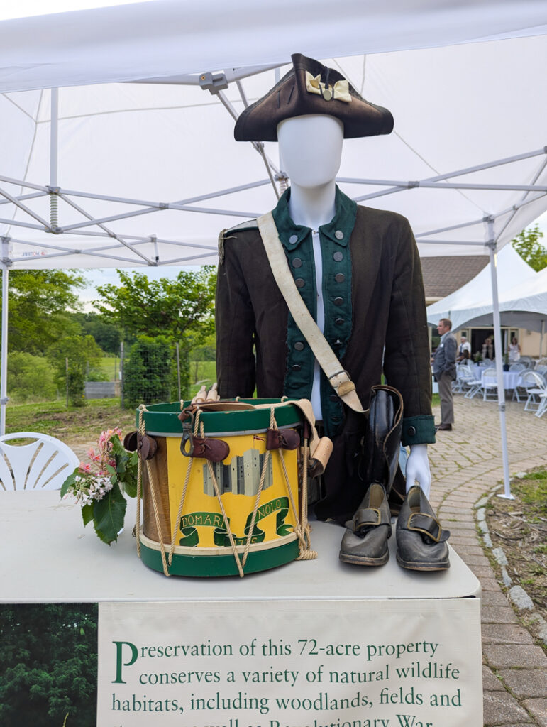 Revolutionary period drum costume and instrument on table