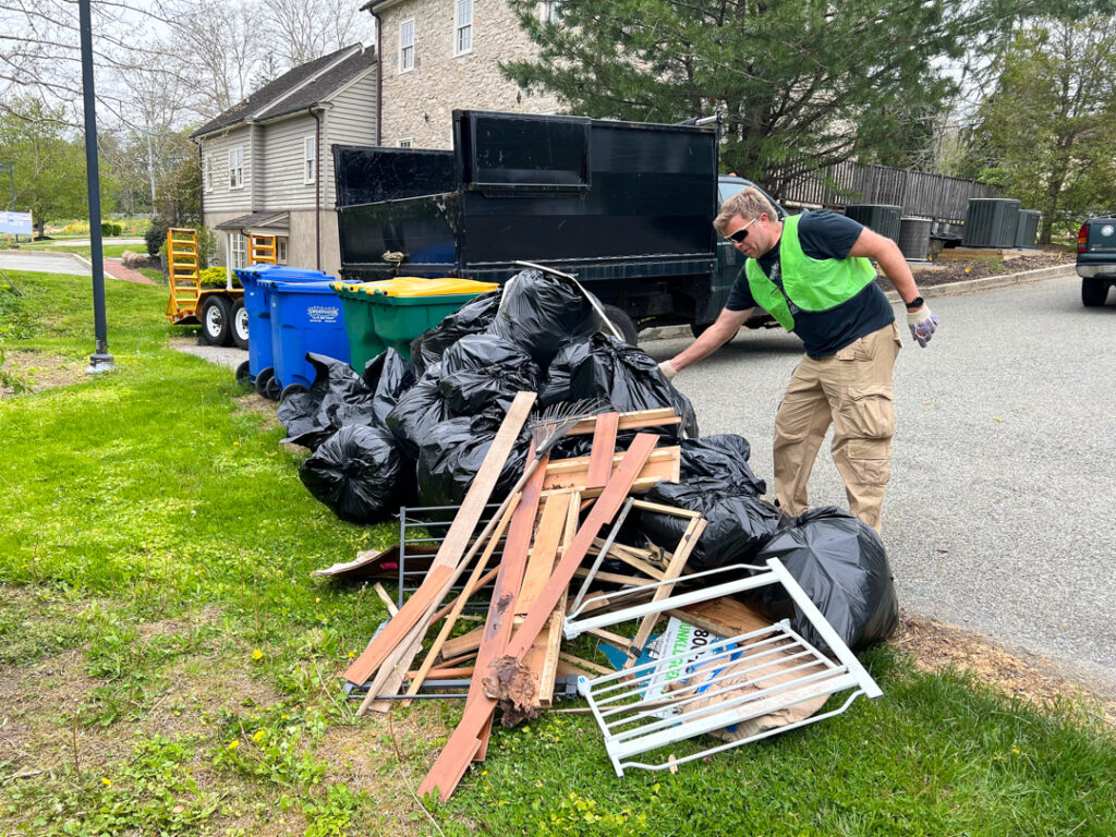 Gathering trash collected at the roadside cleanup