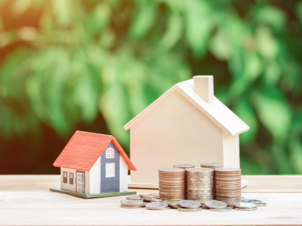 wooden houses in front of coins; representing the property tax rebate program